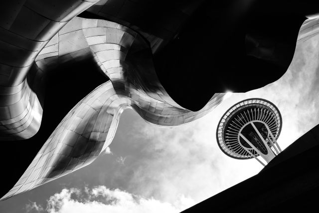 The Space Needle in Seattle, seen in the clouds through the structure of the Museum of Pop Culture.