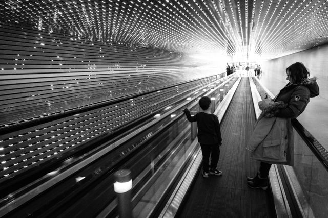 A woman and a child on the walkway of Leo Villareal's Multiverse installation at the National Gallery of Art.