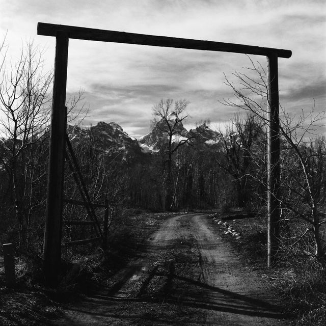 The wooden gate to 4 Lazy F Ranch, with the Grand in the background.