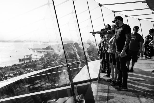 A group of people looking at Seattle from the top of the Space Needle.