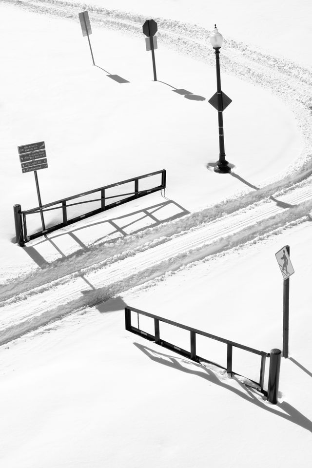 Tire tracks in the snow going through a gate at Anacostia Park.