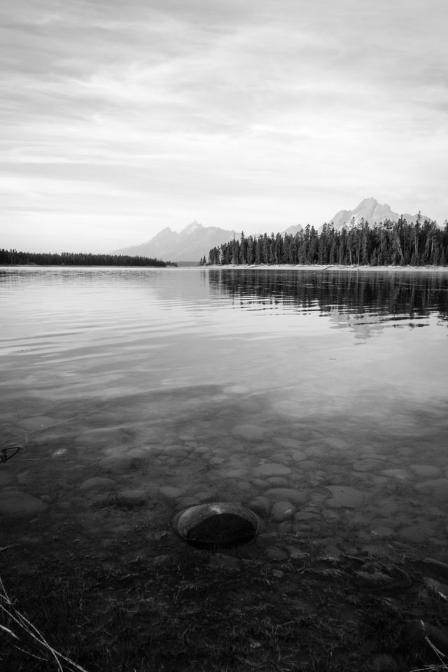 A rock on the shore of Jackson Lake at Grand Teton National Park, with the Tetons and Mt. Moran in the background.