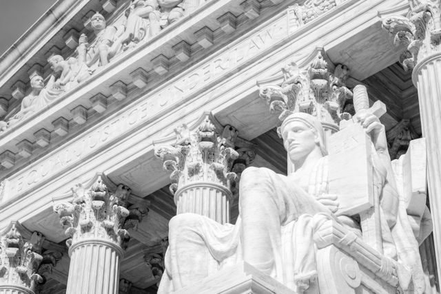 One of the statues in front of the United States Supreme Court.