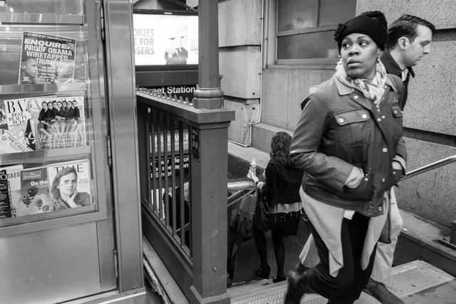 A woman walking out of a subway station.