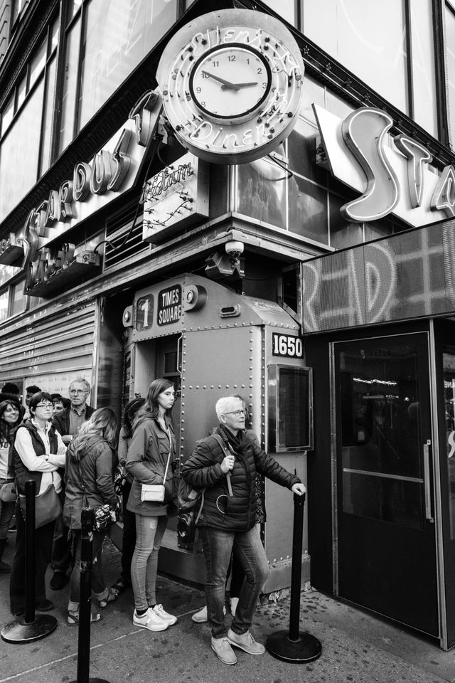 People waiting in line outside Ellen's Stardust Diner in New York City.