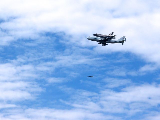 Discovery flying over the National Mall atop the Shuttle Carrier Aircraft.