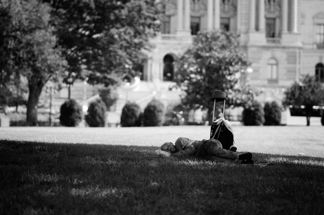 A man sleeping on the ground at the United States Capitol.