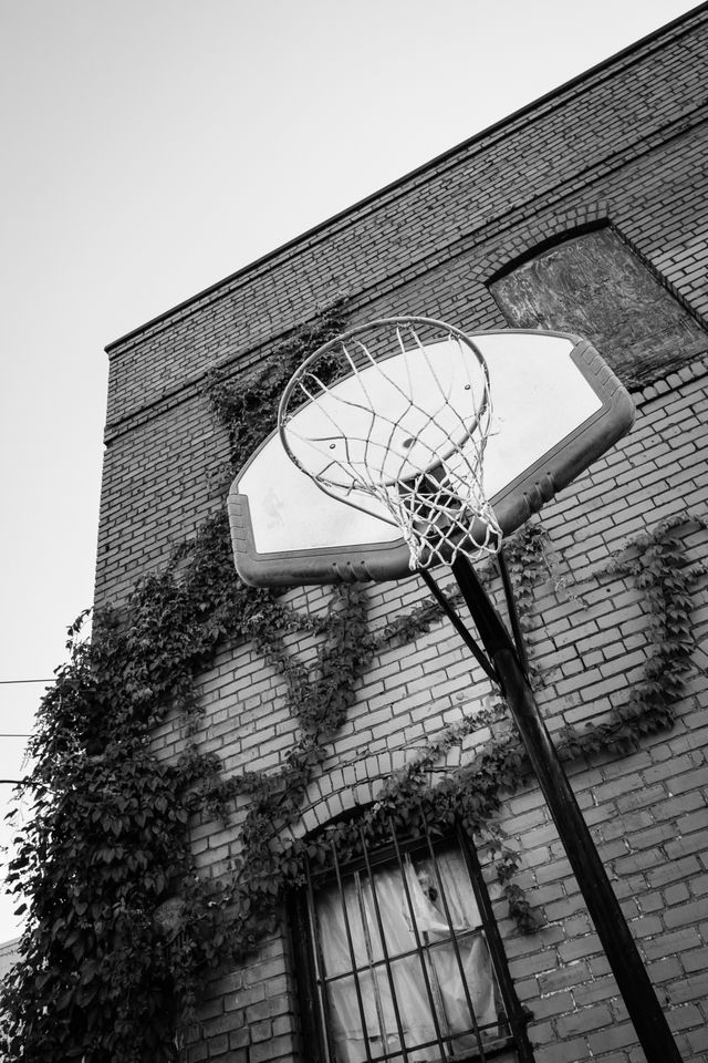 A basketball hoop next to an abandoned building in Chattanooga.