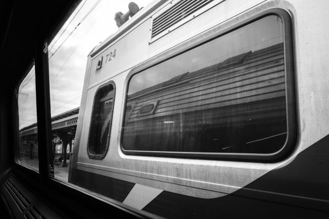 A train reflected on another train's window at Wilmington Station.