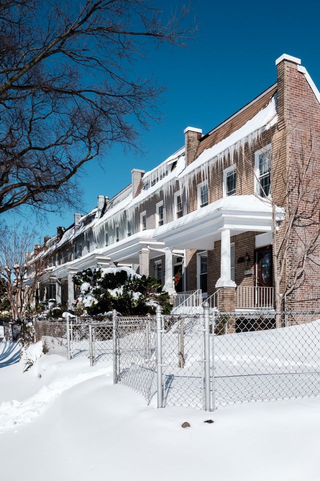 Snow-covered row houses in Capitol Hill, with icicles hanging from their roofs.