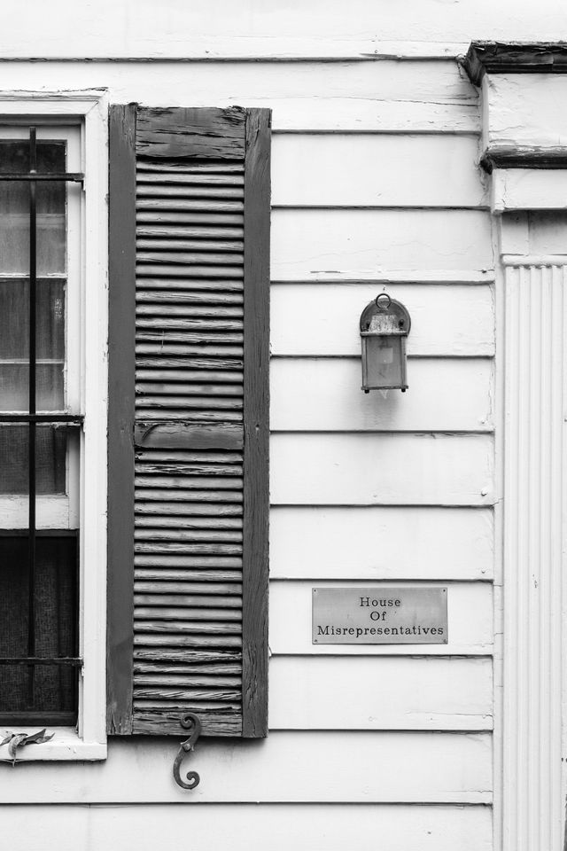 A row house in Capitol Hill bearing a plaque that reads "House of Misrepresentatives".