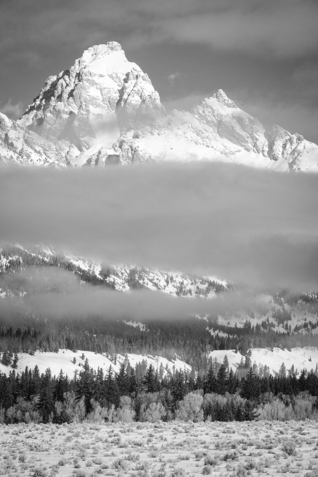 Grand Teton, seen half-covered in clouds at Grand Teton National Park.