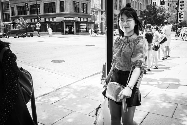 A pedestrian in front of the Leica Store in Washington, DC.