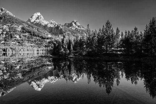 Grand Teton and Teewinot Mountain, reflected in the waters of Taggart Lake.