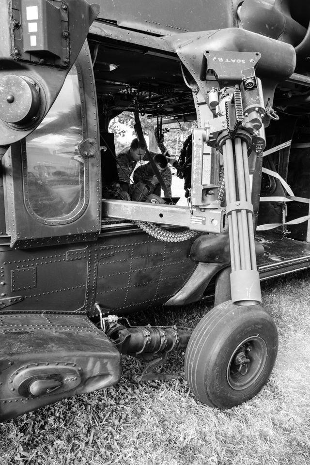 Soldiers working on an MH-60M helicopter at the DC Armory.