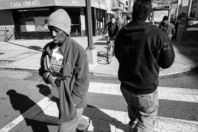 A pair of people crossing the street near Columbia Road in Adams Morgan.