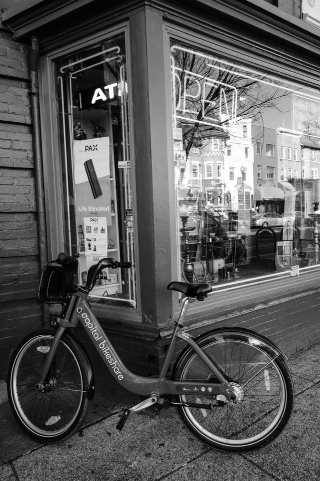 A Capital Bikeshare bike parked in front of a convenience store in Adams Morgan.