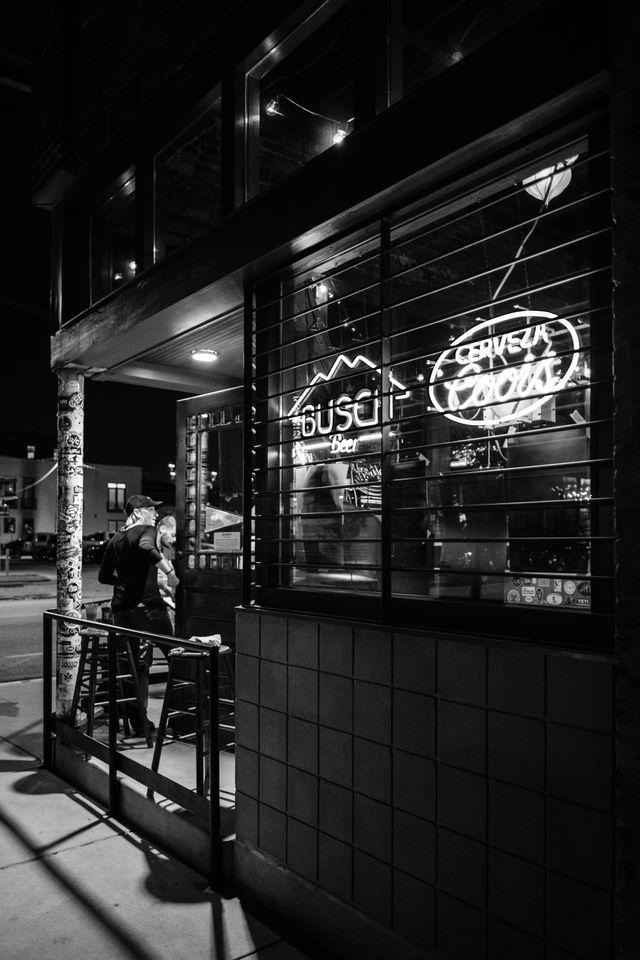 People walking into Clyde's on Main, a bar in Chattanooga, at night.