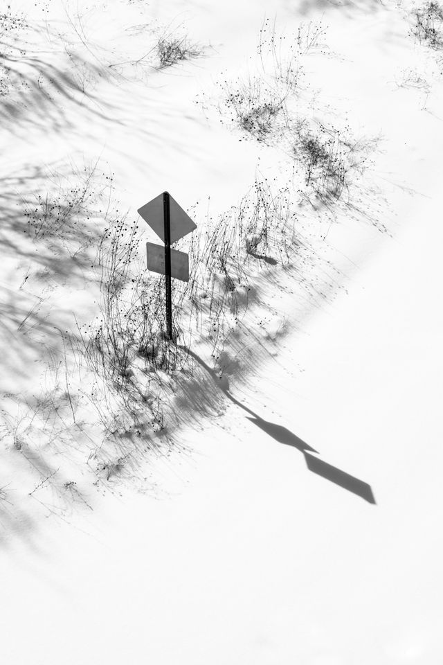 A road sign on a road-covered snow.