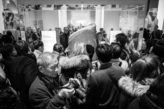 The Rosetta Stone, surrounded by British Museum visitors.