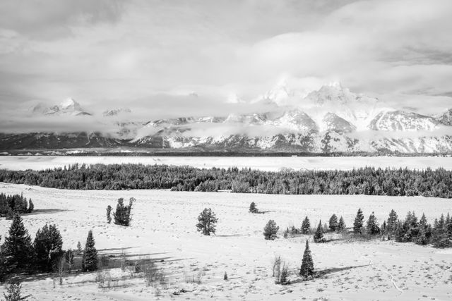 The Teton Range, seen partially hidden by clouds during winter, from the Teton Point turnout.