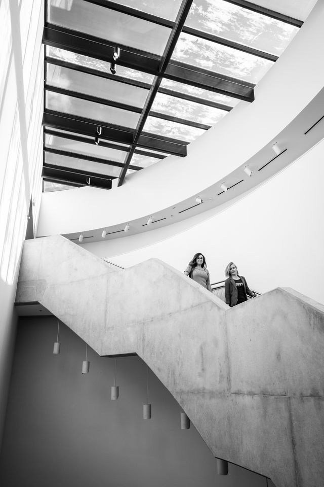 People walking down the stairs at the Katzen Arts Center at American University.