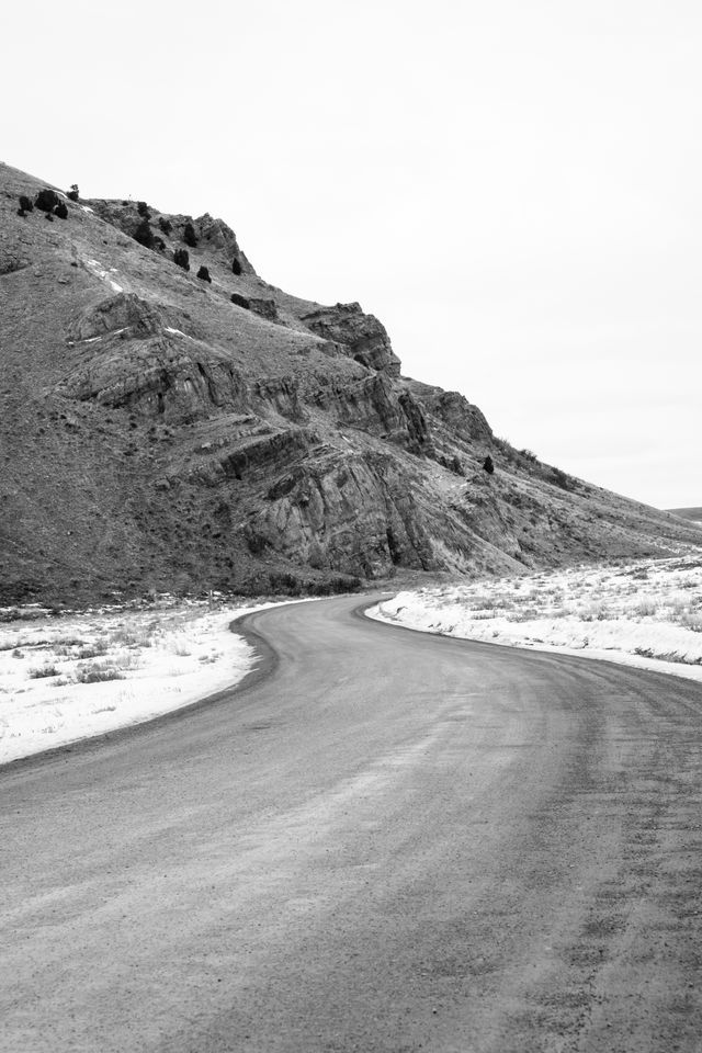 A winding road at the National Elk Refuge, leading past Millers Butte.