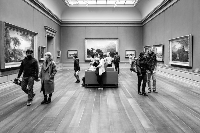 People watching art at the west building of the National Gallery of Art.