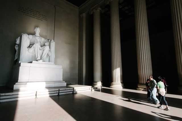 Tourists walking up to the statue of Abraham Lincoln at the Lincoln Memorial in Washington, DC.