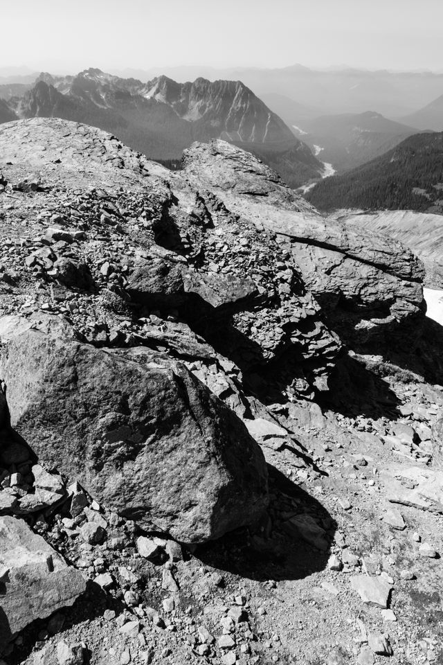 Jagged rocks at the very top of the Skyline Trail on Mount Rainier National Park, with the Nisqually River in the distant background.