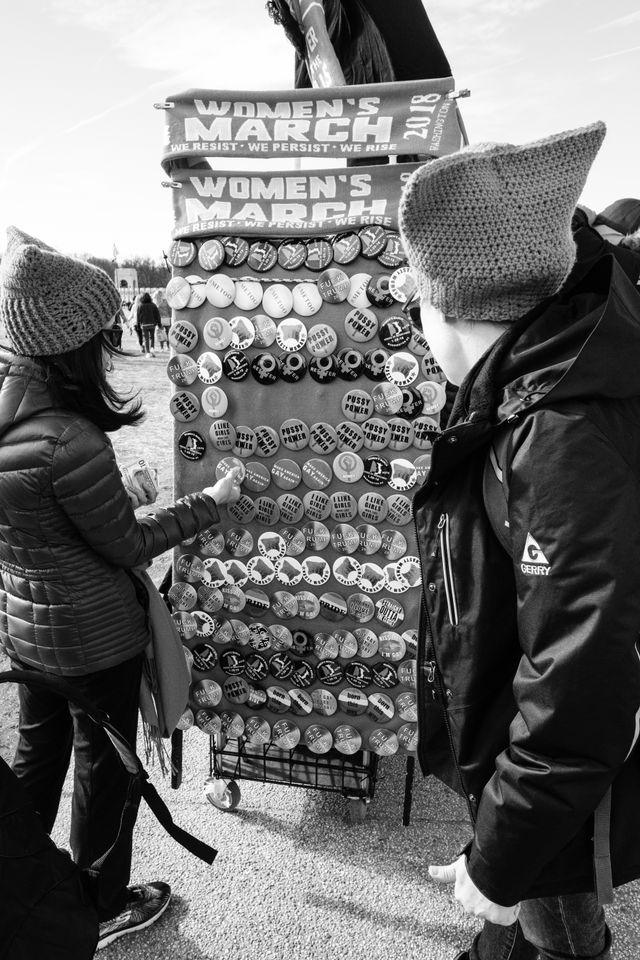 Women looking at buttons for sale at the Women's March in Washington, DC.