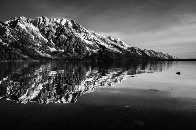 Storm Point, Symmetry Spire, Mount Saint John, and Mount Moran, seen reflected on the surface of Jenny Lake.