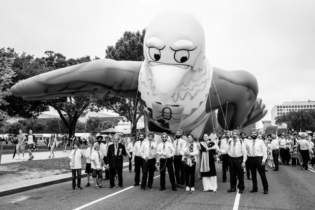 A group of american Sikhs under an inflatable eagle.