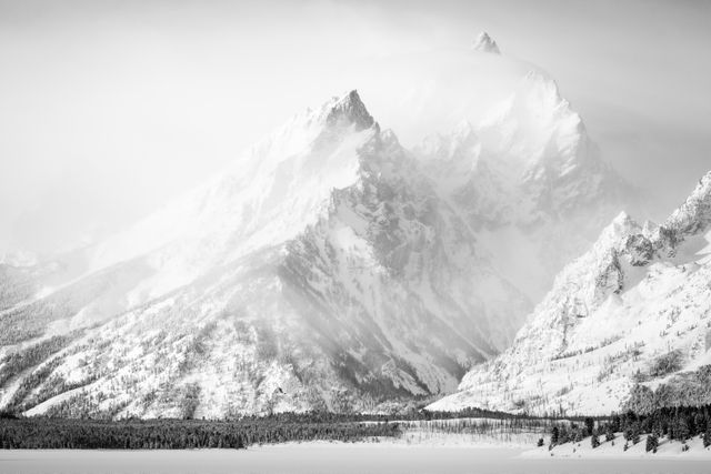 The Teton range, partially shrouded in clouds in the morning, seen from the Willow Flats Turnout.