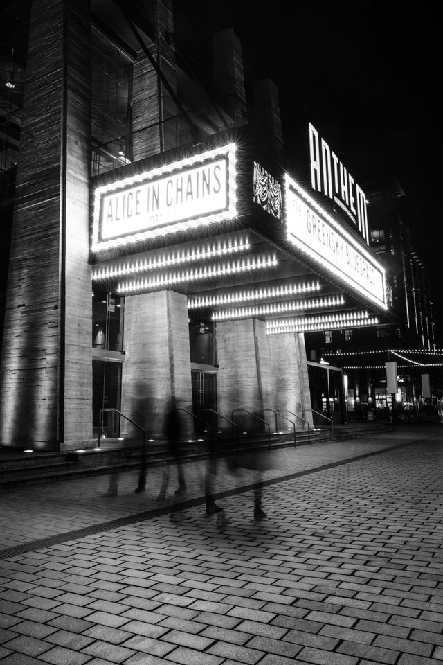 A group of people walking at night in front of the Anthem in Washington, DC.