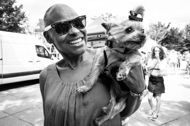 A little dog called Teacup, being held by her owner at Eastern Market.