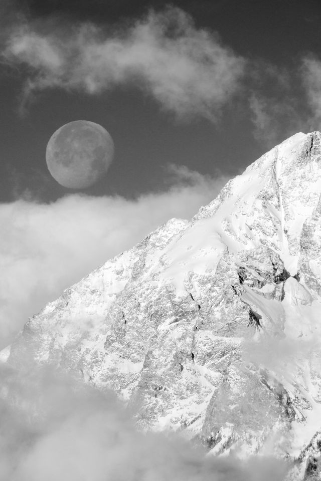 The moon setting behind the Tetons.