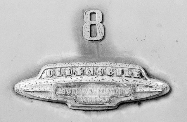 The badge of an old Oldsmobile with "hydramatic drive".