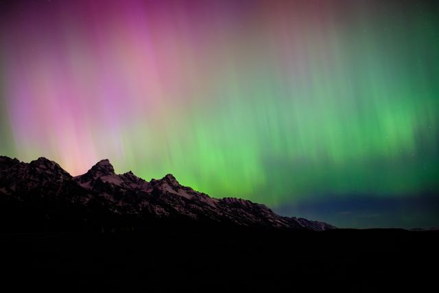 The Teton Range, seen at night under the Aurora Borealis.