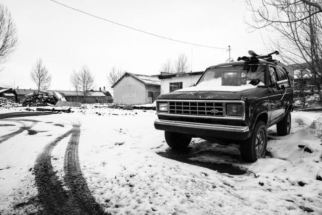 A snow-covered Ford Bronco parked in Jackson, Wyoming.