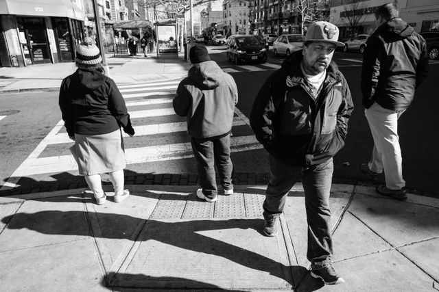 A group of people crossing the street near Columbia Road in Adams Morgan.