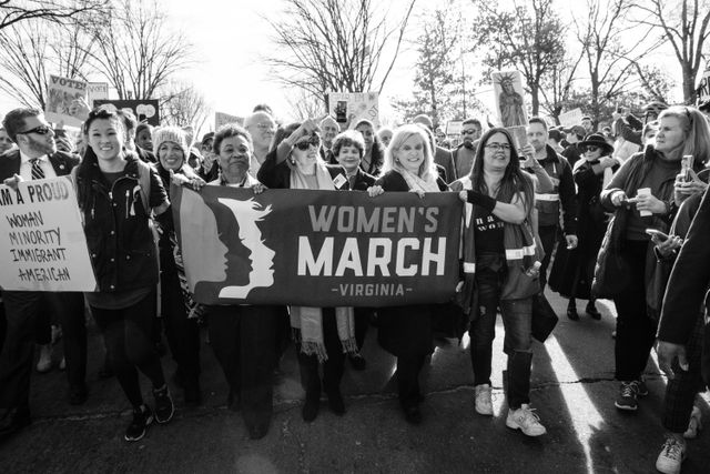 Nancy Pelosi marching with protesters at the Women's March in Washington, DC.