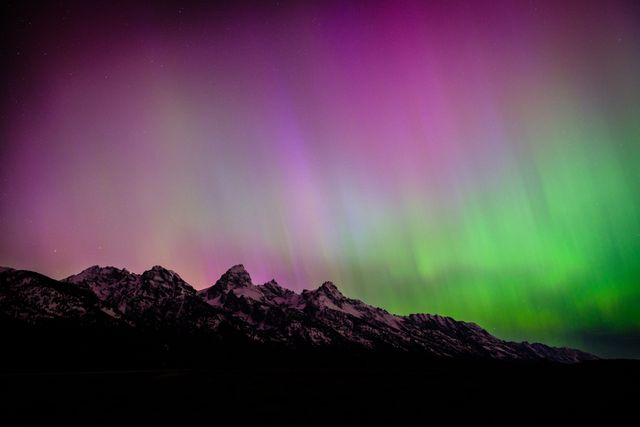 The Teton Range, seen at night under the Aurora Borealis.