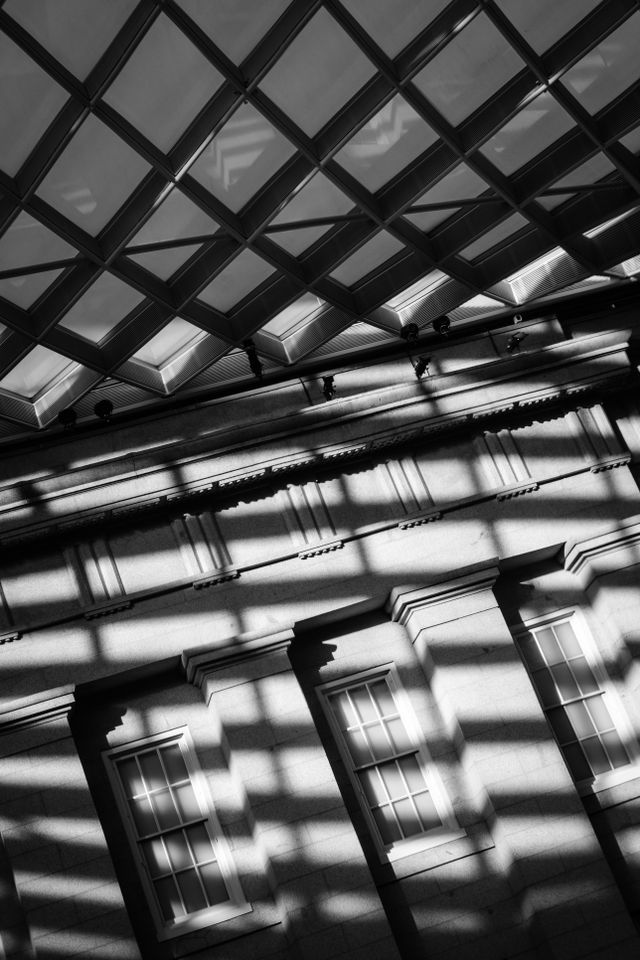 Shadows cast by the canopy of the Kogod Courtyard at the National Portrait Gallery on three windows of its internal facade.