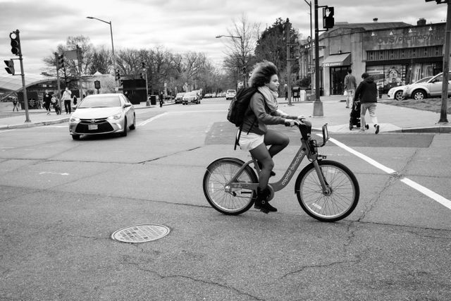 A woman riding a Capital Bikeshare bike on Pennsylvania Avenue SE, near Eastern Market.