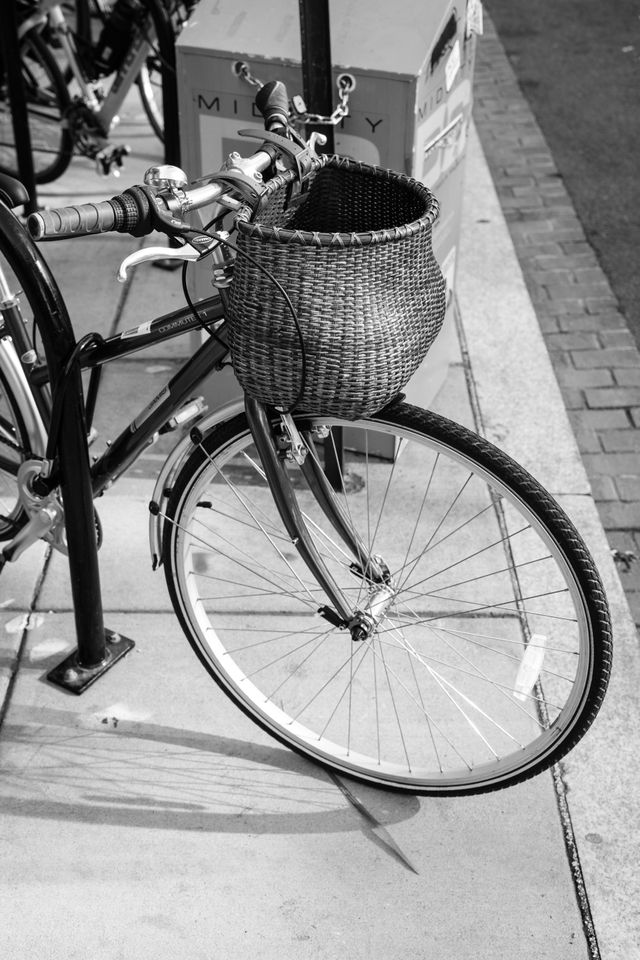 A bicycle with a wicker basket on 14th Street.