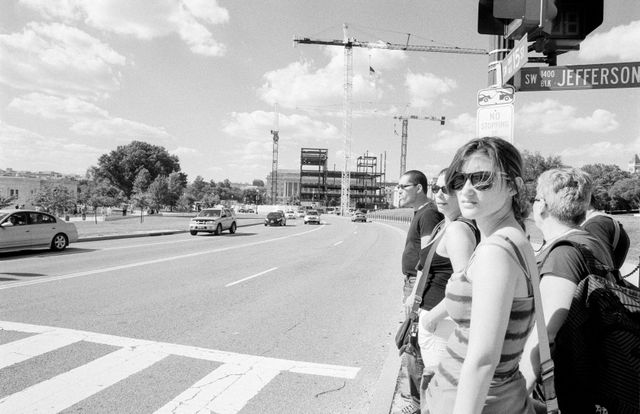 Tourists waiting to cross the street near the Washington Monument.