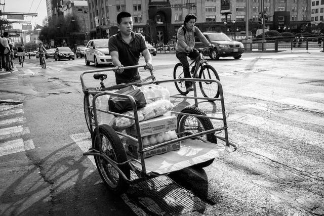 A man pushing a cart in the historic center of Mexico City.