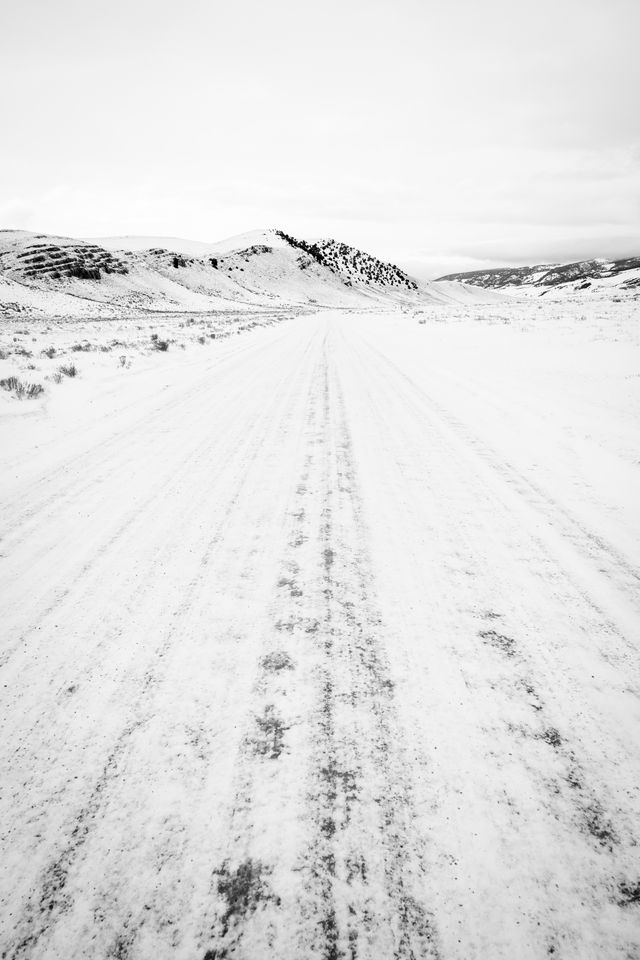 National Elk Refuge road covered in snow, with the north end of Millers Butte in the distance.