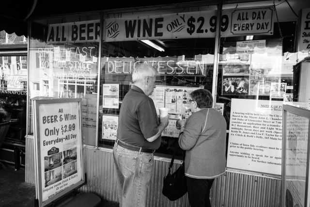 Two people looking at the menu of Chick & Ruth's Delly in Annapolis, Maryland.